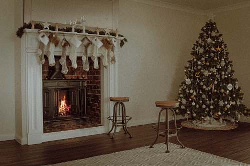 hearth Christmas tree near two barstools at fireplace christmas tree