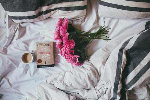 book bouquet of pink flowers on top of bed flower