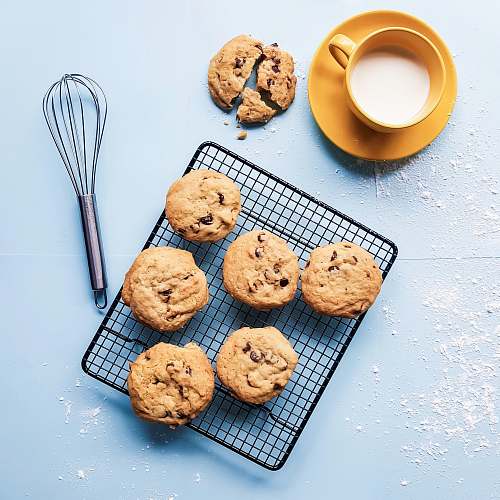 biscuit cookies on black grill beside yellow ceramic cup cookie