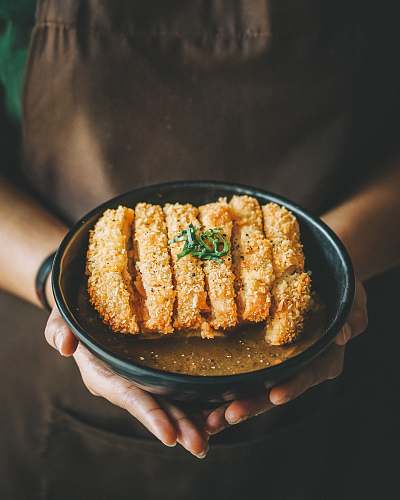 seasoning fried dish on round black plate sesame