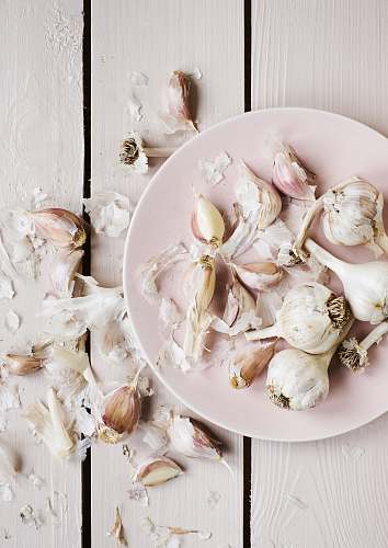 meal garlic cloves on round white plate dish