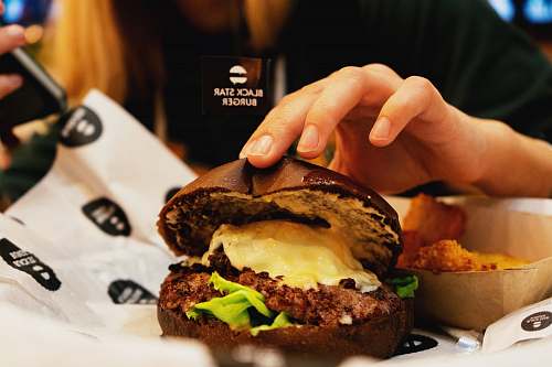 burger person holding burger human