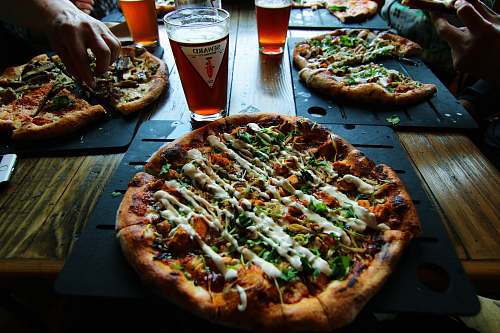 pizza slice pizza on black tray beer