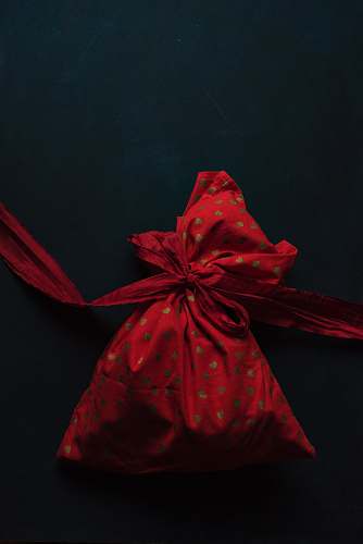 christmas red and gold polka-dot drawstring pack on black surface red