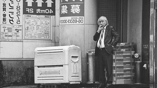 grayscale photo of man smoking cigarette