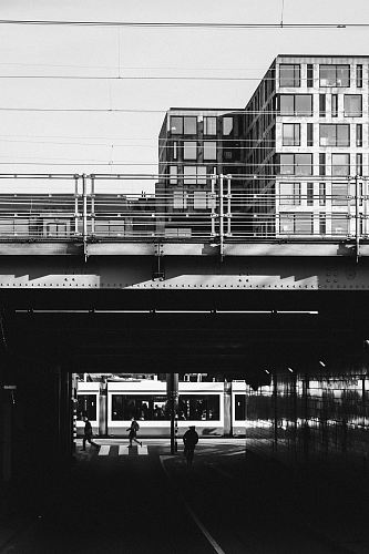 grayscale photograph of train bridge