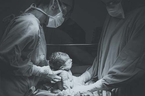 surgery greyscale photo of medical operation birth
