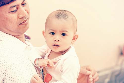 person man holding baby baby