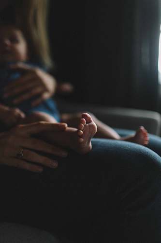 person person carrying baby on lap baby