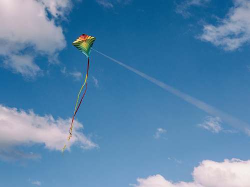 blue green and yellow kite on air cloud