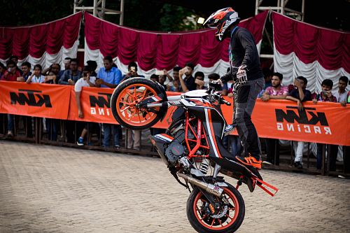 man doing tricks while riding on dirt bike