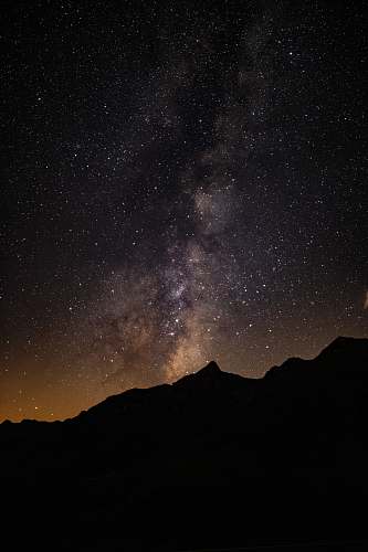 nature silhouette of mountain under starry sky outdoors