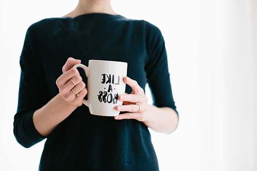 cup woman holding white mug while standing woman