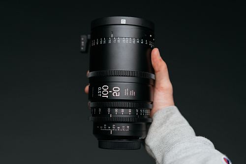 person holding black camera lens