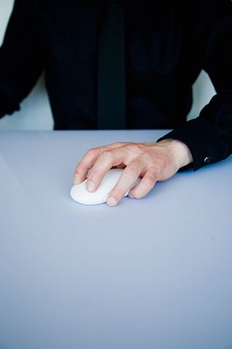 person holding white cordless computer mouse