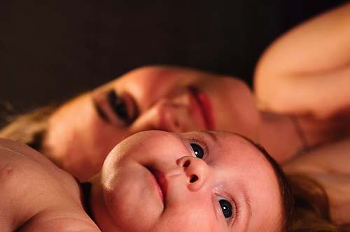 baby shallow focus photography of baby beside woman child