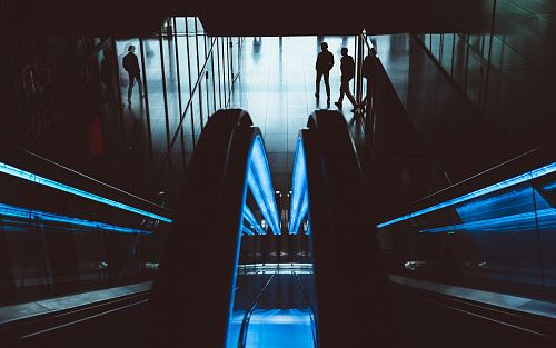 silhouette of two people walking in the hallway
