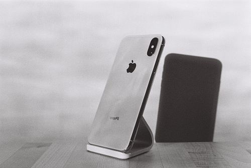 silver iPhone X on stand