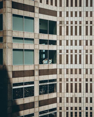 three persons at building window