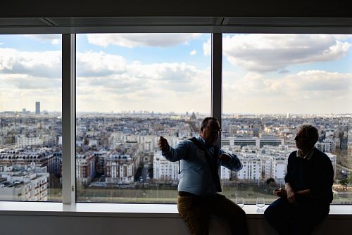 two men sitting on balustrade