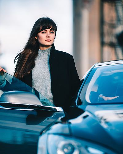 woman standing beside vehicle