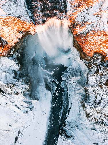 nature waterfalls in between of white rock formation outdoors