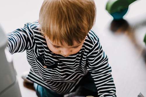 human boy in black and white striped long-sleeved shirt person