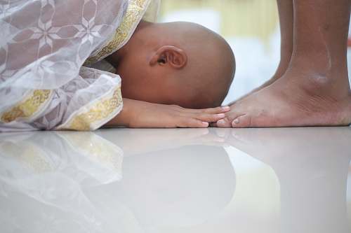 human person bowing before another persn person