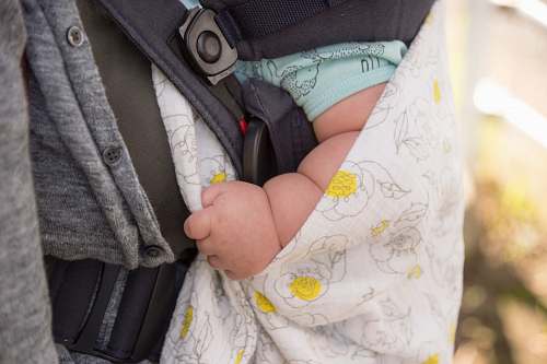 furniture selective focus photography of baby's hand diaper