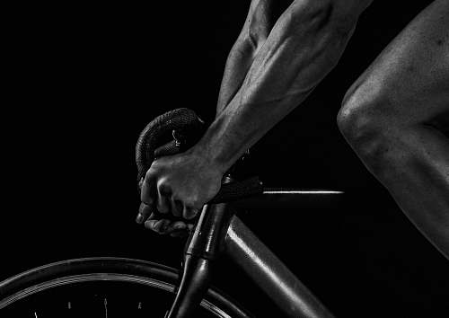 black-and-white grayscale photography of man riding bicycle musical instrument