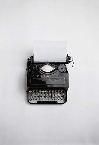 white black Fayorit typewriter with printer paper writing