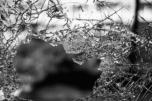 black-and-white macrophotography of cracked glass screen white