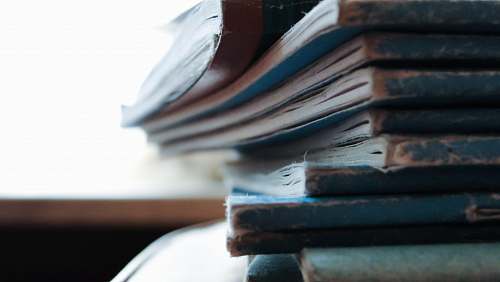 books stacked blue notebooks paper