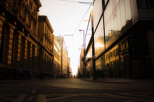 road empty road in between buildings town