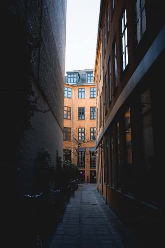 city gray concrete pathway in between high-rise buildings street