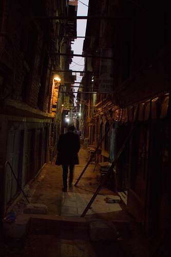 city man walking in the alley road