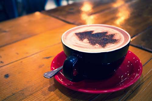 cup blue cup with cappuccino on red bowl bella nova