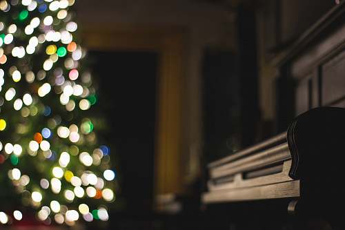 piano closeup photo of black piano near lighted Christmas tree music