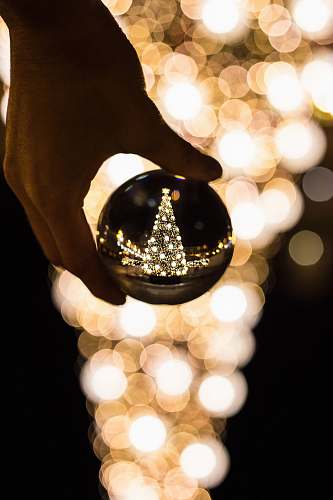 crystal person holding glass bauble lamp