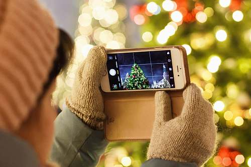 lights person taking photo of Christmas tree moscow