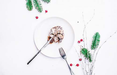 food round plate with pastry and stainless steel fork and knife plate