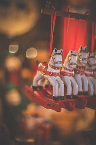 ornament selective focus photography of four horse carousel hanging inside the room dessert