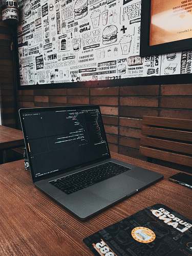 electronics MacBook Pro on brown wooden table pc