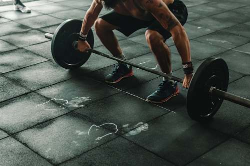 machine man holding dumbbells wheel