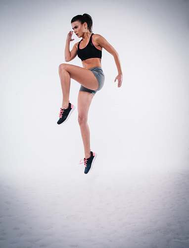 people woman jumping near white wall paint sport