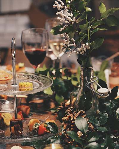 glass clear glass 2-tier plate beside flower arrangement wine