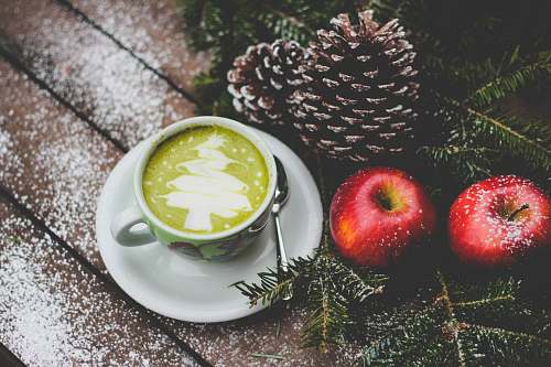 apple white ceramic mug beside red apples flora