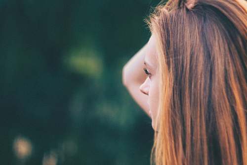 woman selective focus of woman holding her head at daytime female