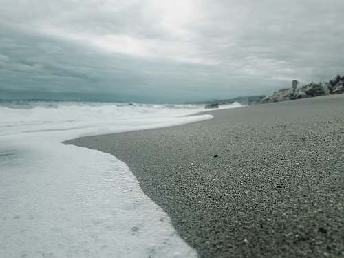 sea beach under cloudy sky beach