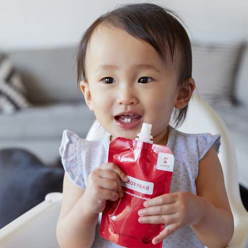 person baby drinking juice pack baby